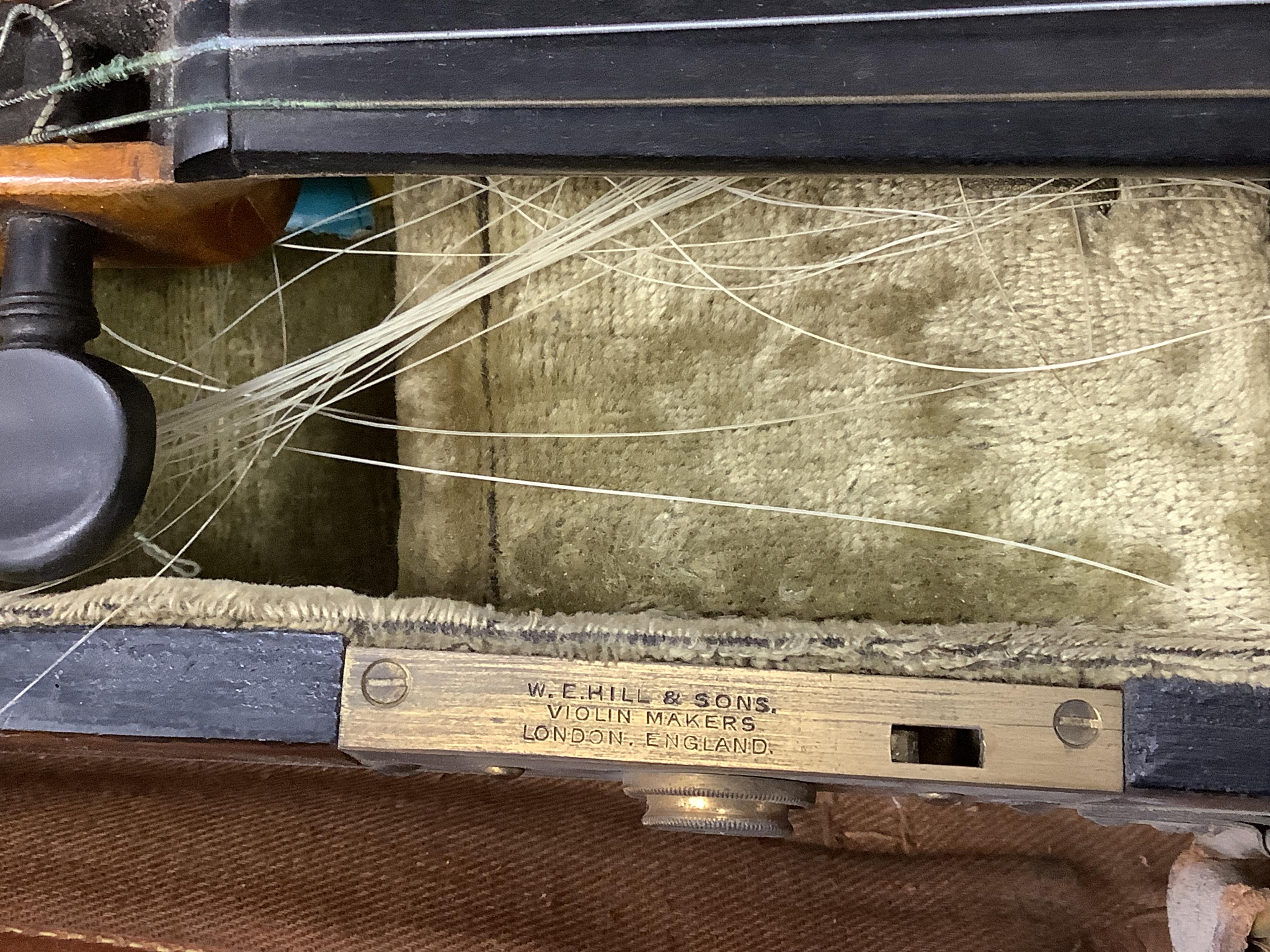 A late 19th century German violin in a Hill & Son oak case, with Hill canvas slip cover, together with an unbranded silver mounted bow, and another, ivory submission ref: 9HJU3B45 and ZC2E1GCP